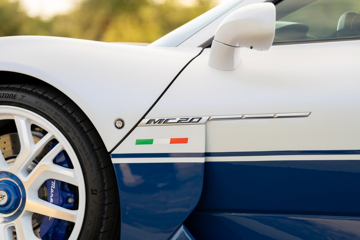 White Maserati MC20 Icona with blue livery and Italian flag accent.