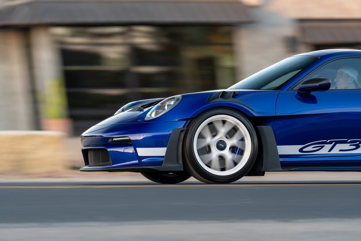 Blue 2025 Porsche 911 GT3 RS with white GT3 livery and multi-spoke rims.