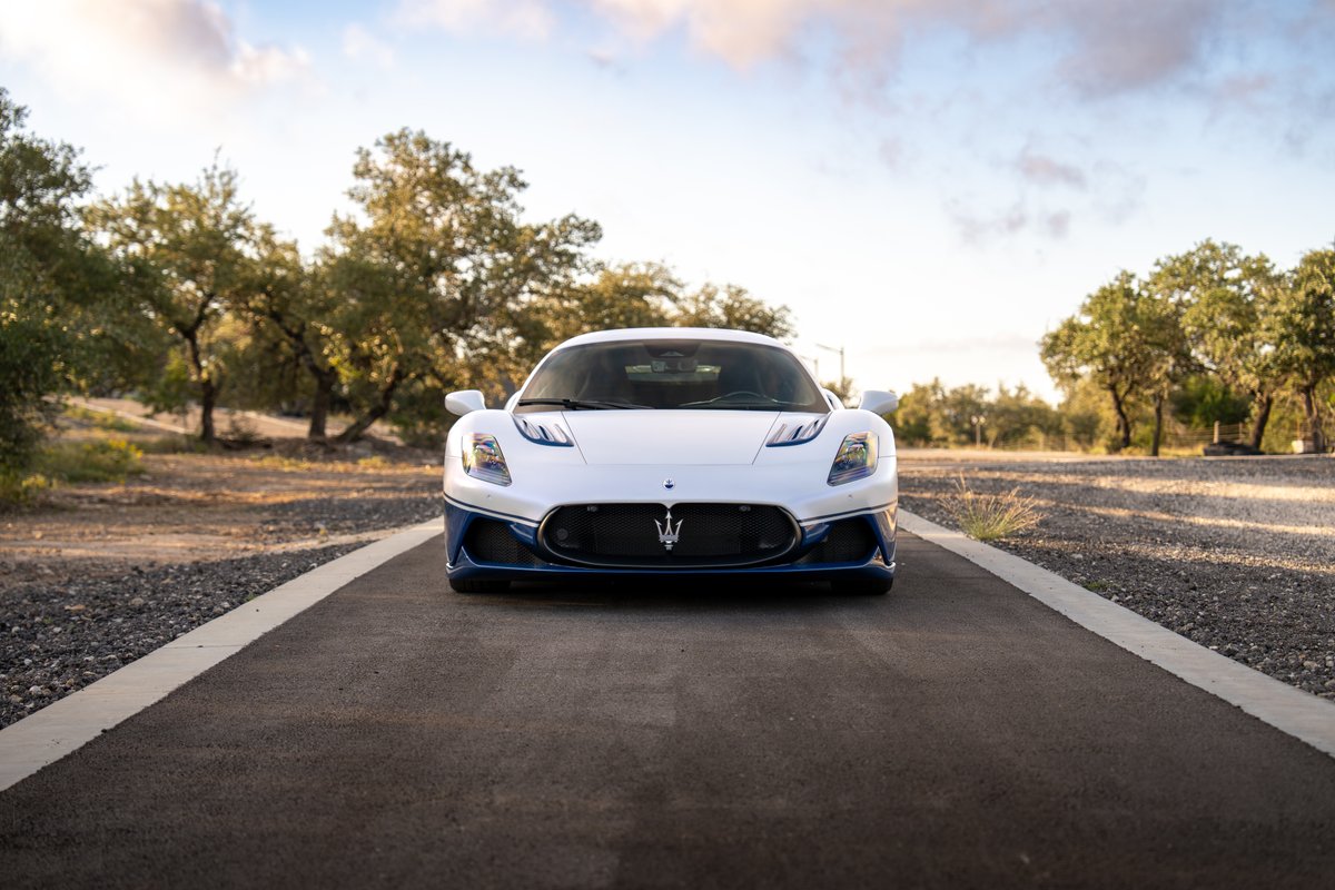 Front view of a white 2024 Maserati MC20 Icona with blue accents and trim on the front fascia.