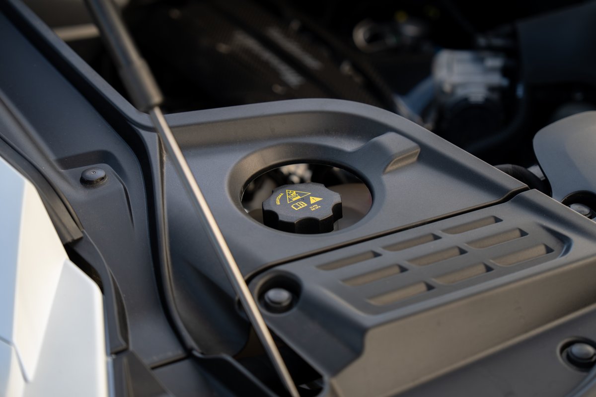 Close-up of the 2024 Maserati MC20 Icona coolant cap under the hood.