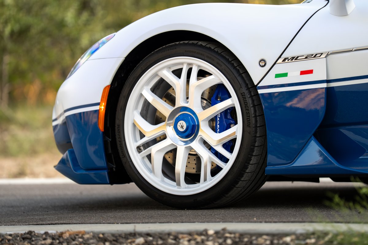 White 2024 Maserati MC20 Icona with blue livery, white rims, and blue calipers.