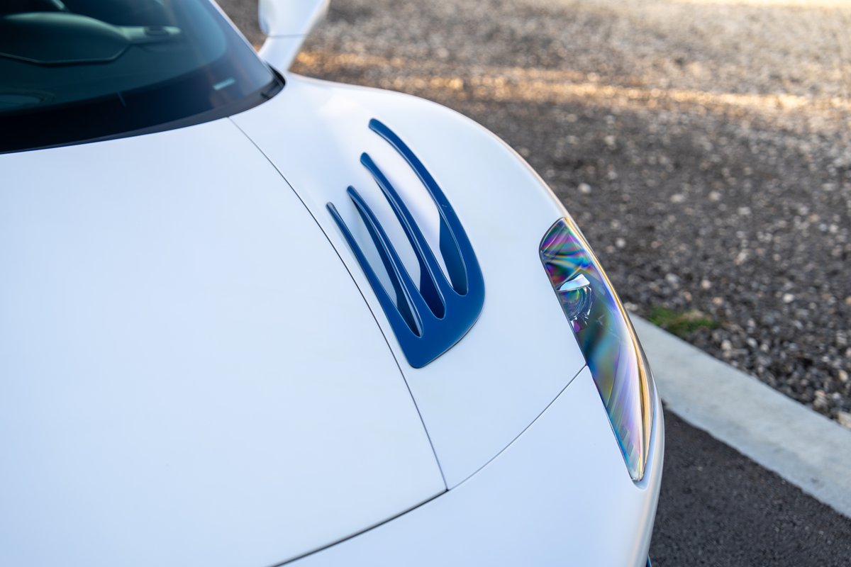 2024 Maserati MC20 Icona in white with blue vents and iridescent headlights.