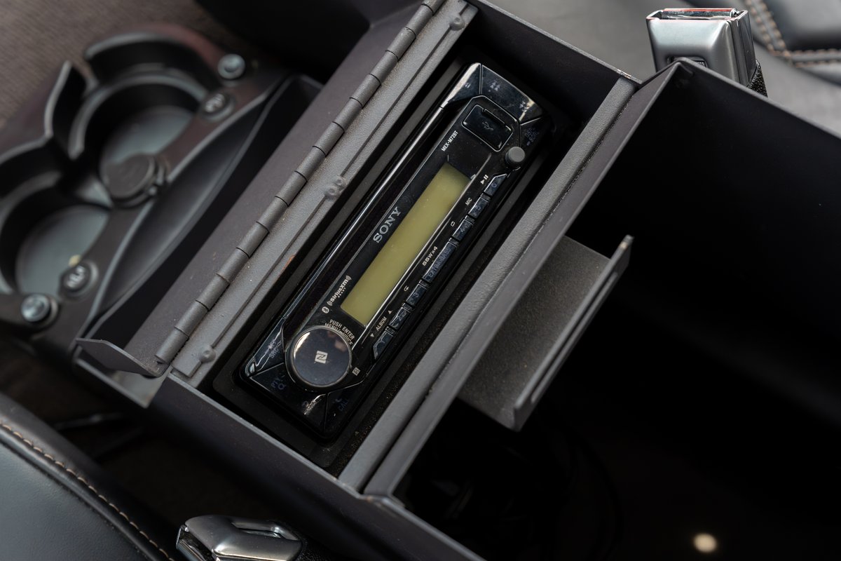 Close-up of the center console of a Ford Bronco, featuring a Sony stereo and cup holders.