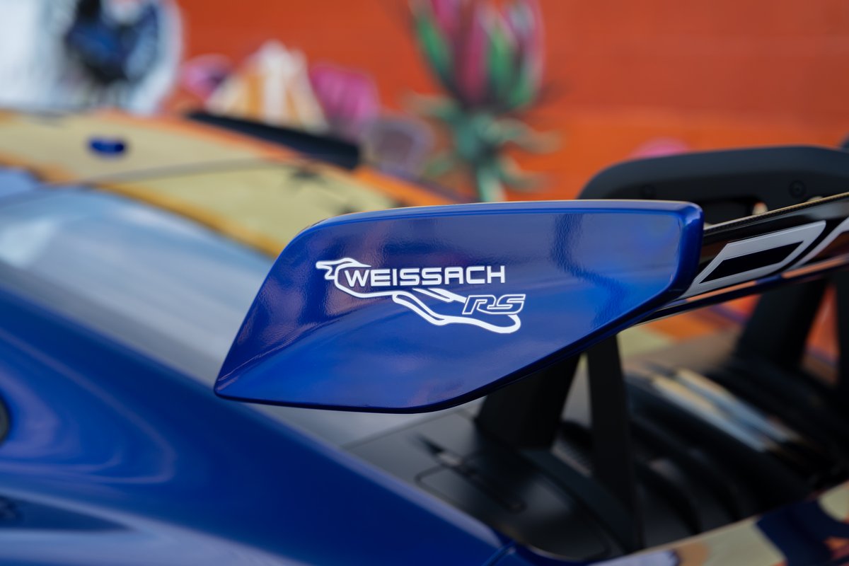 Close-up of a blue 2025 Porsche 911 GT3 RS rear wing with Weissach RS livery.