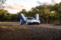 White 2024 Maserati MC20 Icona with blue livery and scissor doors open.