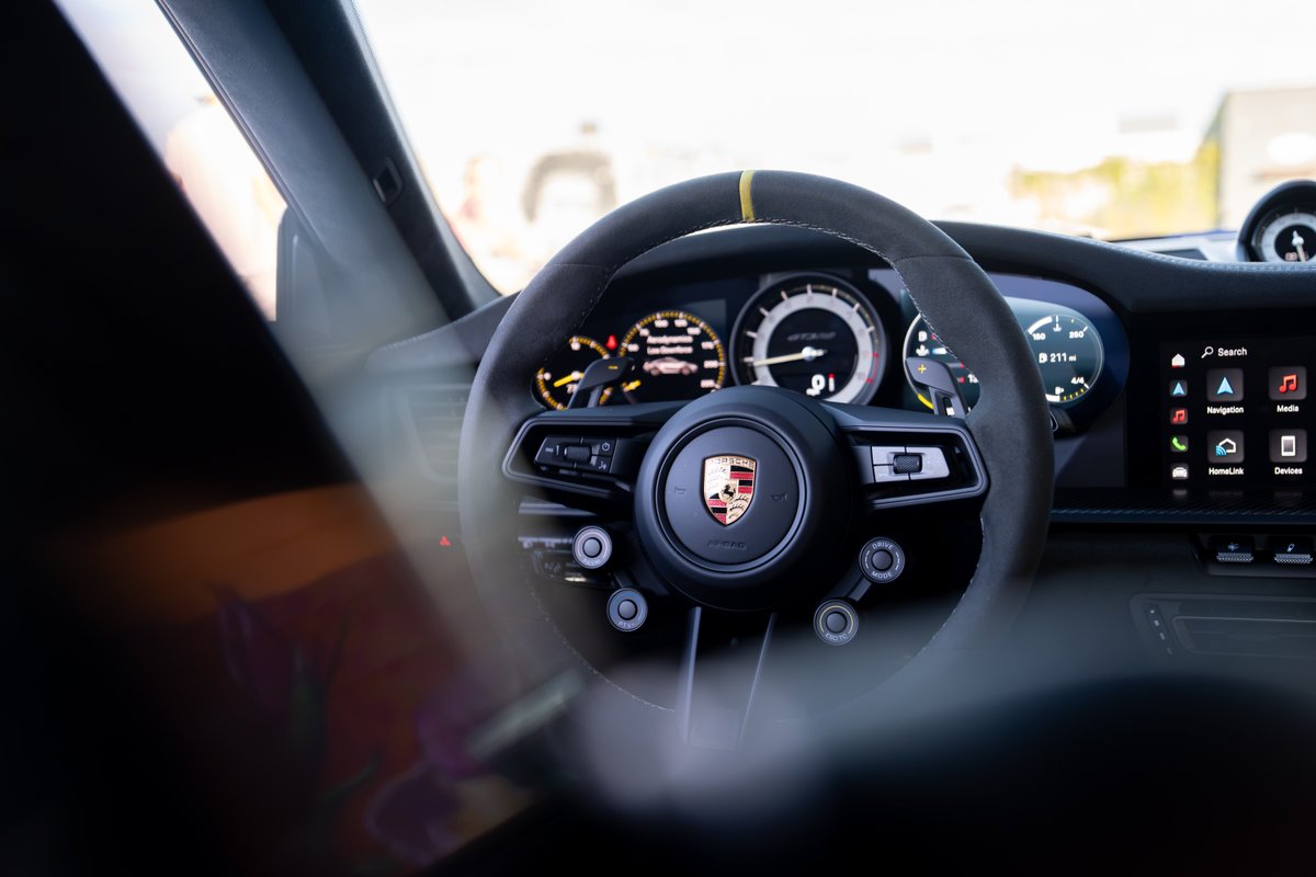 2025 Porsche 911 GT3 RS interior: Alcantara steering wheel, analog tachometer, digital display.