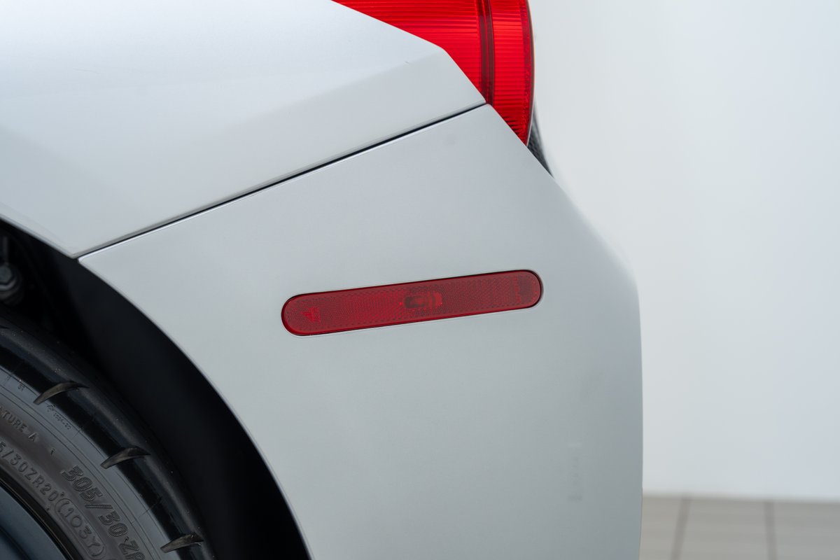 Rear red reflector on a white 2015 Ferrari 458 Speciale.