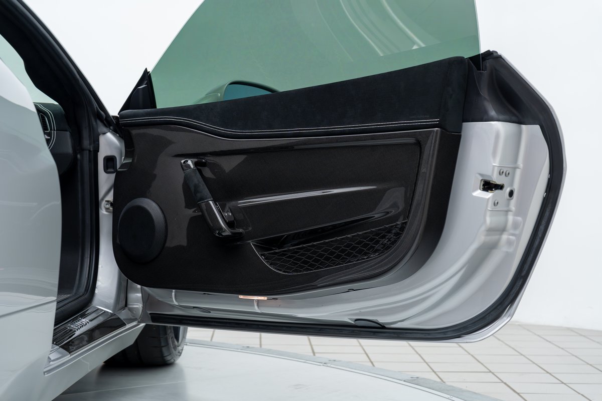 2015 Ferrari 458 Speciale interior door panel with carbon fiber trim and silver exterior.