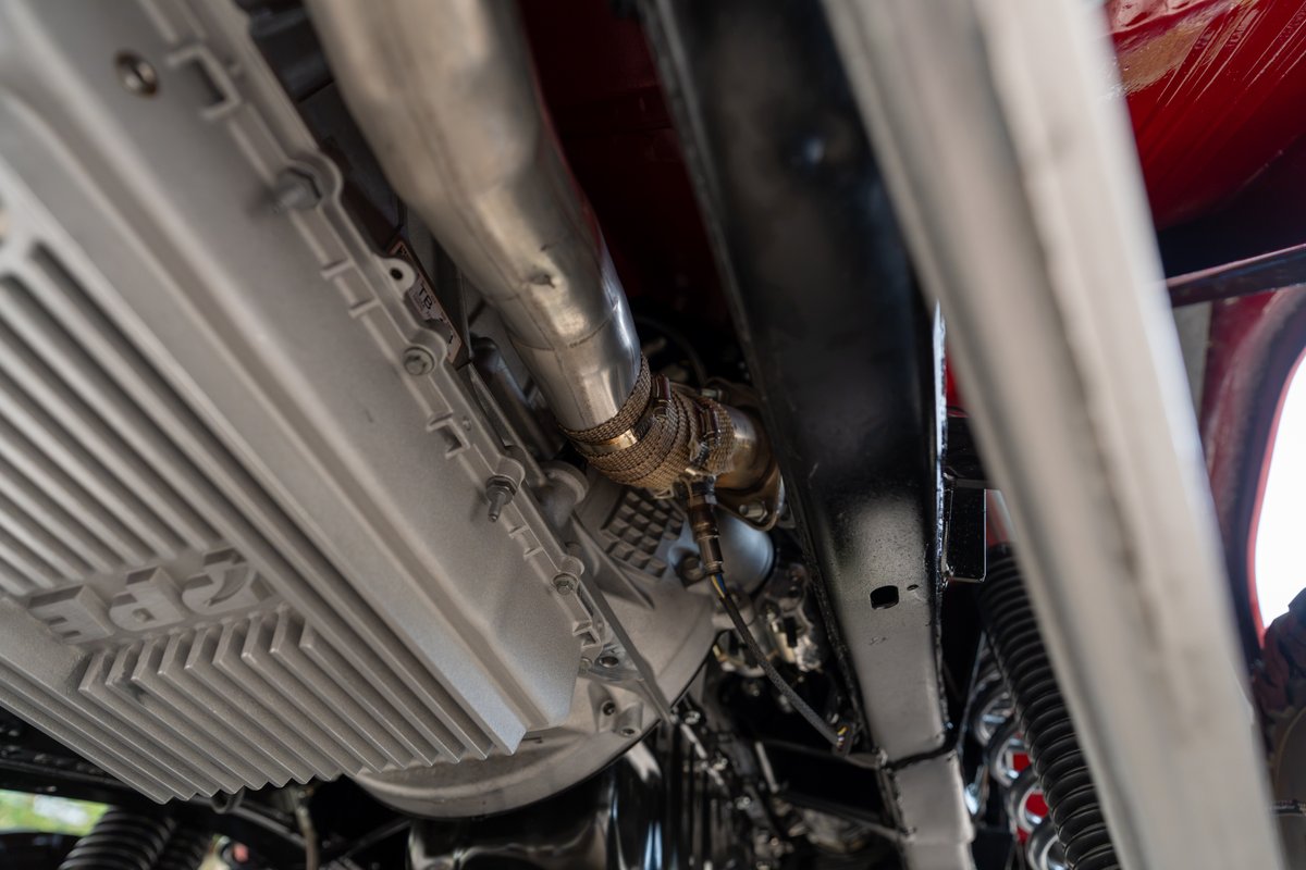 Underside view of a 1966 Ford Bronco by Atlas Broncos, showing the transmission pan and exhaust system.