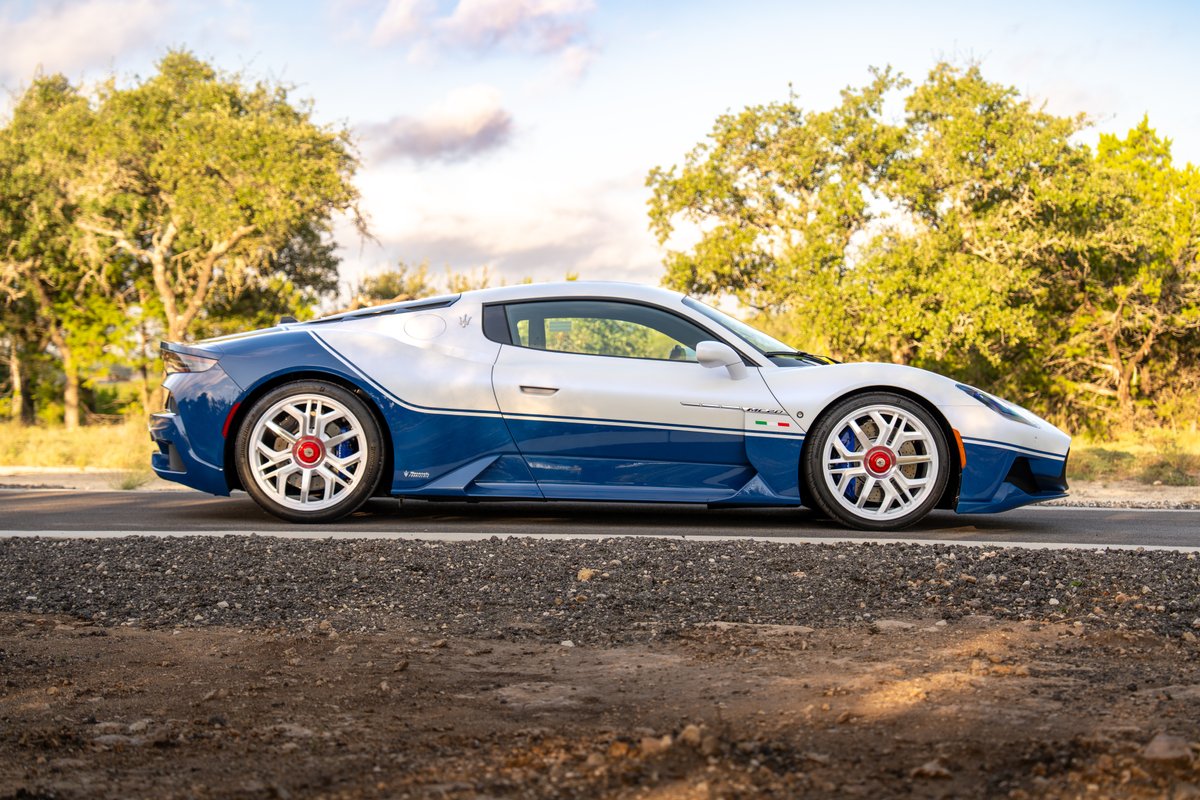 Side profile of the Maserati MC20 Icona in white and blue livery with distinctive silver rims.