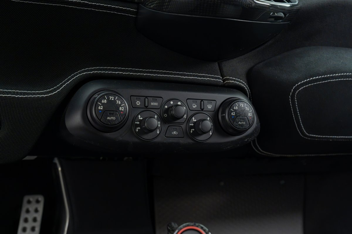Interior climate controls with dual-zone temperature dials in a black 2015 Ferrari 458 Speciale.