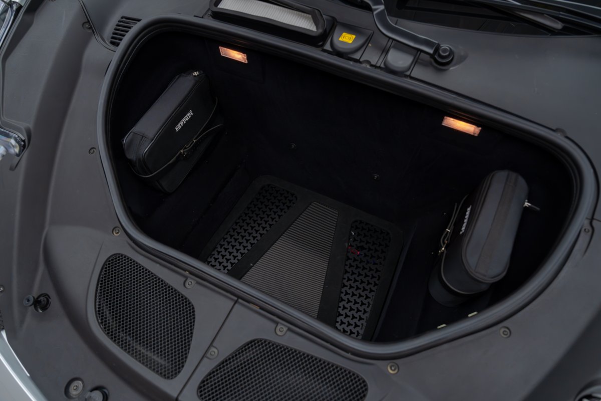 2015 Ferrari 458 Speciale trunk with luggage bags and rubber floor mat.