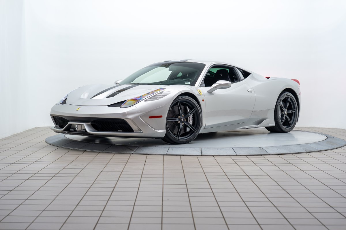 2015 Ferrari 458 Speciale in silver with black racing stripes, matte black rims, and carbon fiber trim.