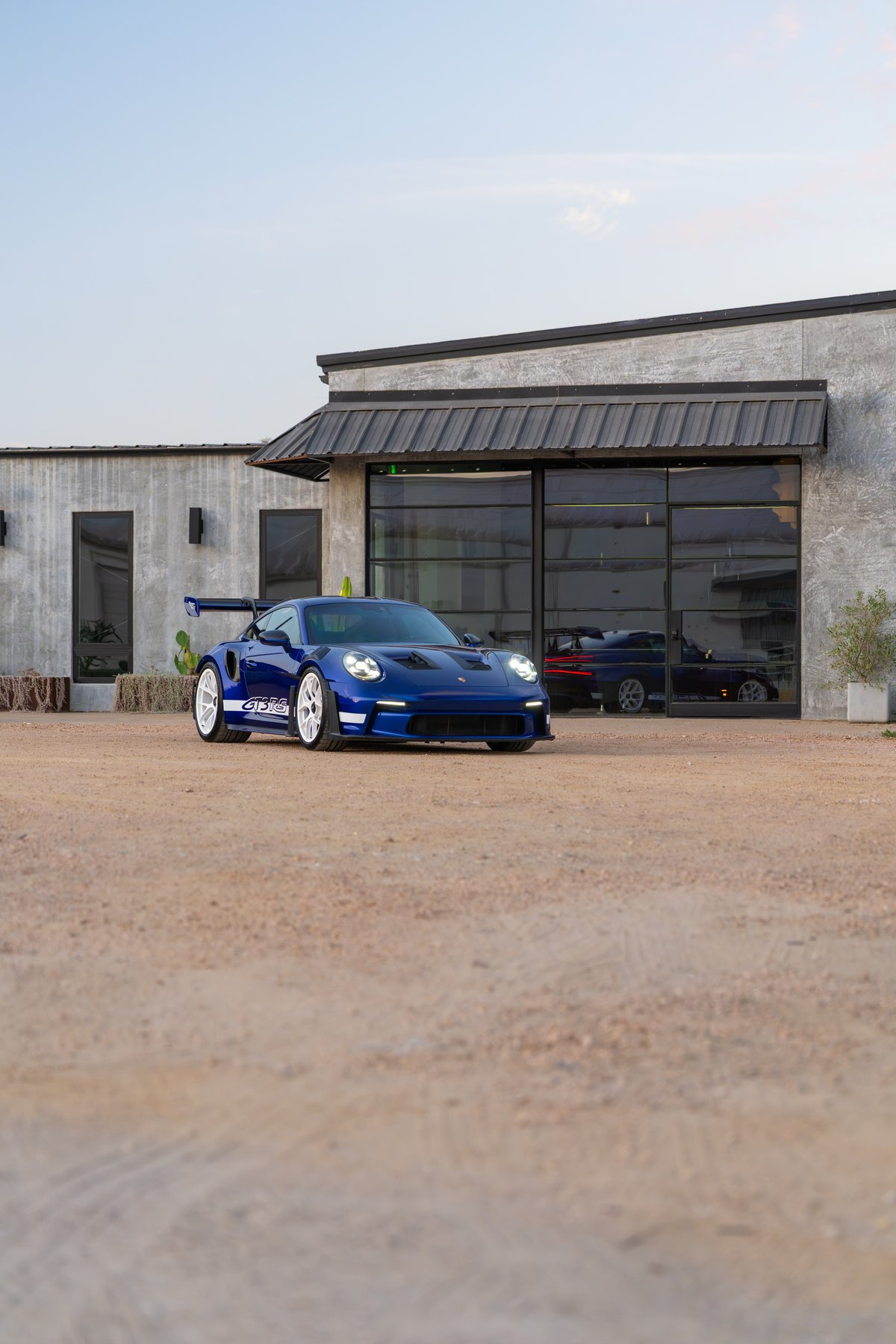 Blue 2025 Porsche 911 GT3 RS with white rims and GT3 RS livery.