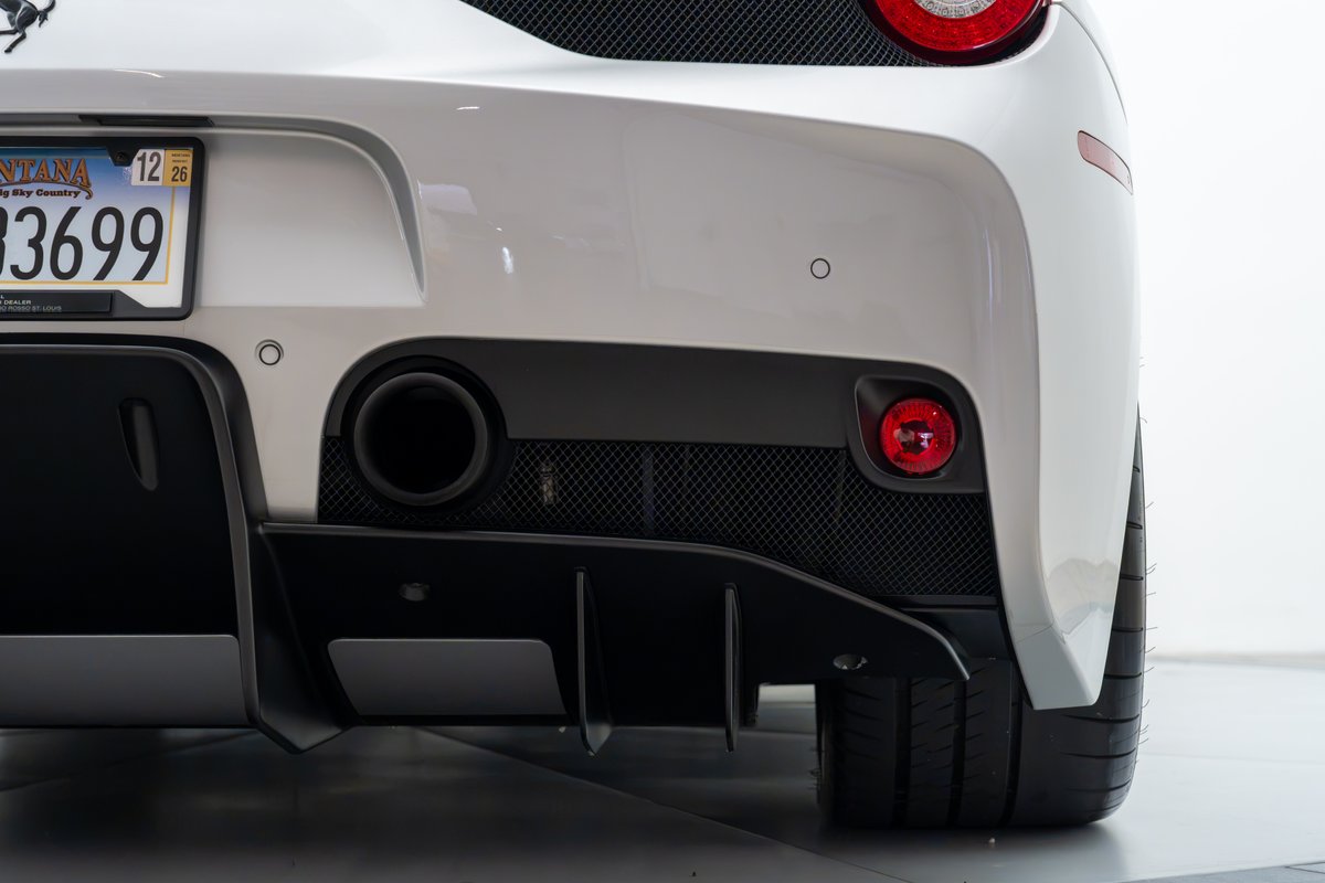 2015 Ferrari 458 Speciale rear bumper with quad exhaust, black diffuser, and red taillights.