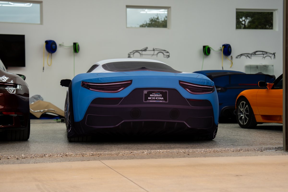 Rear view of a blue and white Maserati MC20 Icona prototype with a custom livery.