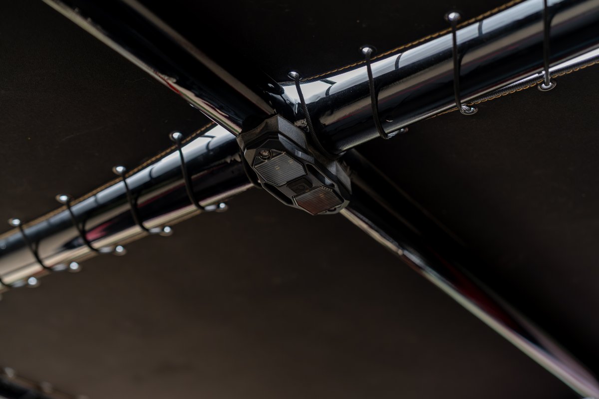 Close-up of a black, aftermarket rear reflector and roll cage on a 1966 Ford Bronco.