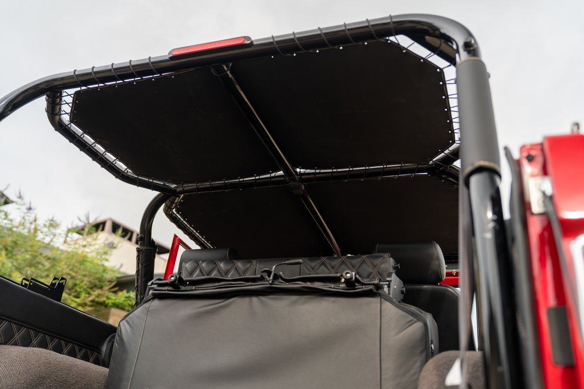 1966 Ford Bronco by Atlas Broncos features a black bikini top and diamond-stitched interior accents.
