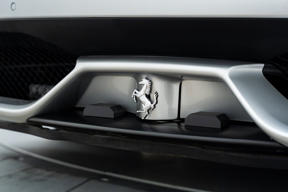 Rear badge of a silver 2015 Ferrari 458 Speciale.