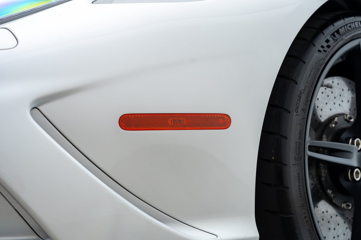 White 2015 Ferrari 458 Speciale with orange side marker reflector.
