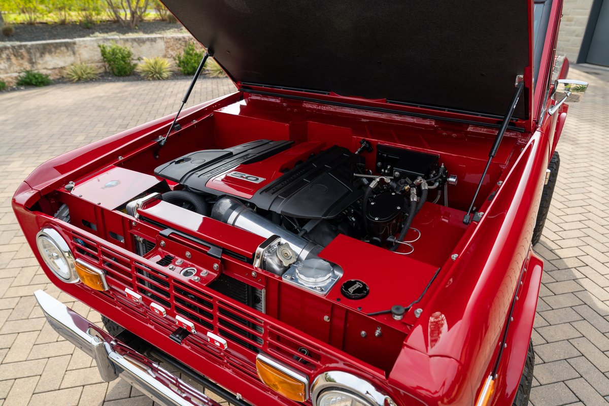 Red 1966 Ford Bronco with a Ford 5.0 V8 Coyote engine swap.