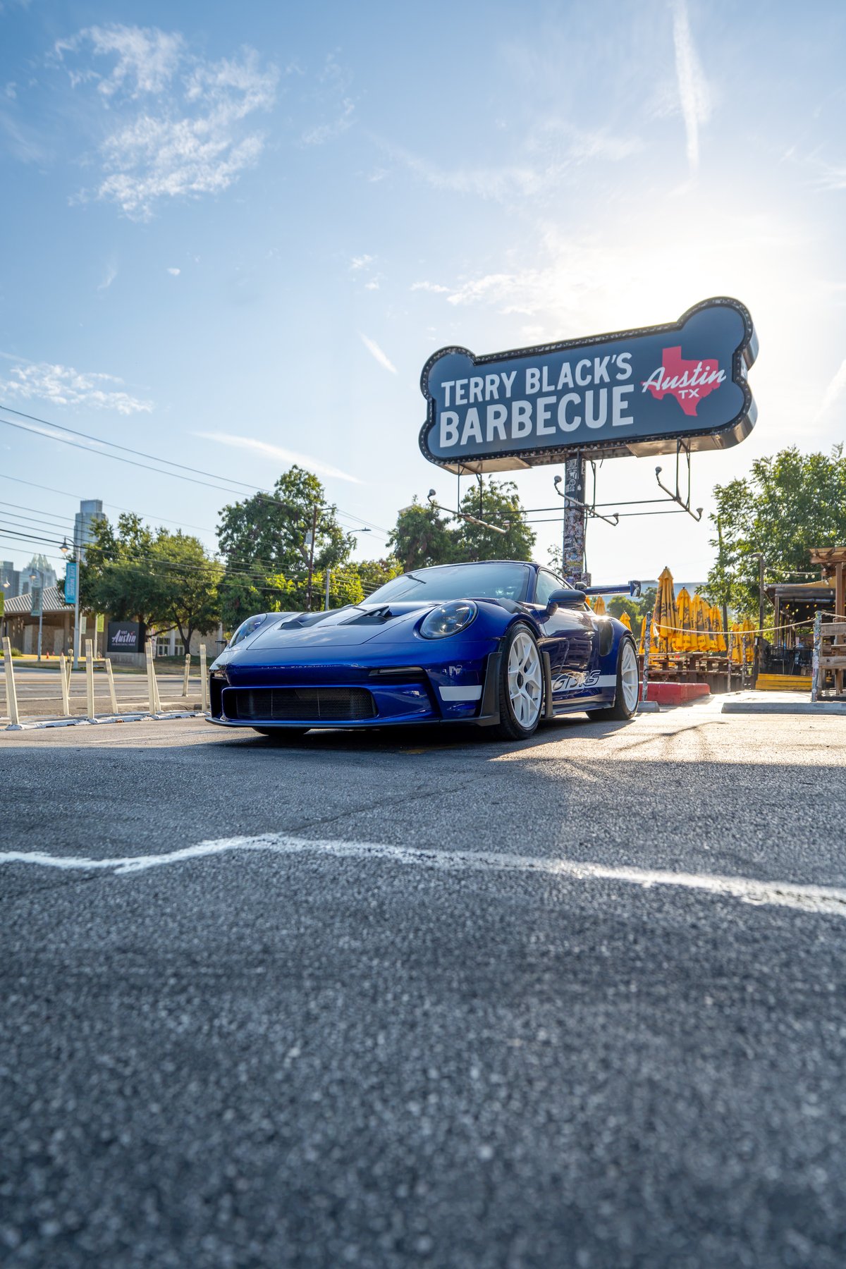 Blue 2025 Porsche 911 GT3 RS with white rims and GT3 RS livery.