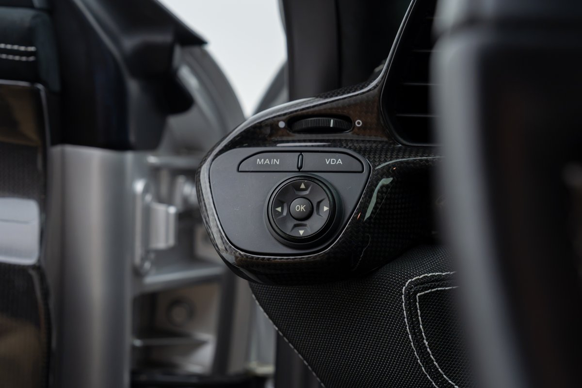 2015 Ferrari 458 Speciale interior with carbon fiber trim and steering wheel controls.