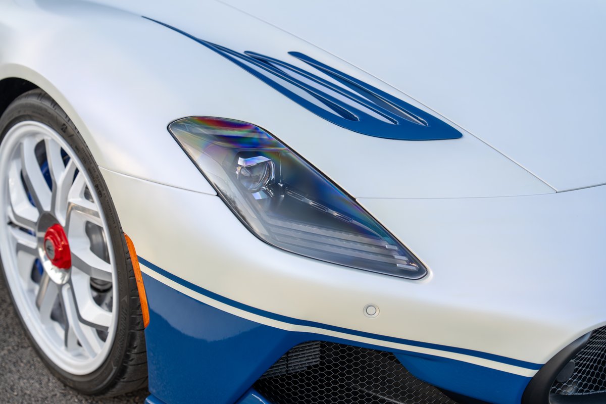 2024 Maserati MC20 Icona in white with blue racing livery, white rims, and unique hood accents.