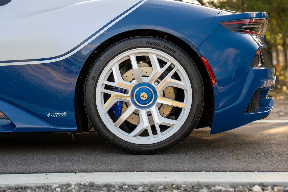 2024 Maserati MC20 Icona in blue with white livery, silver rims, and blue brake calipers.