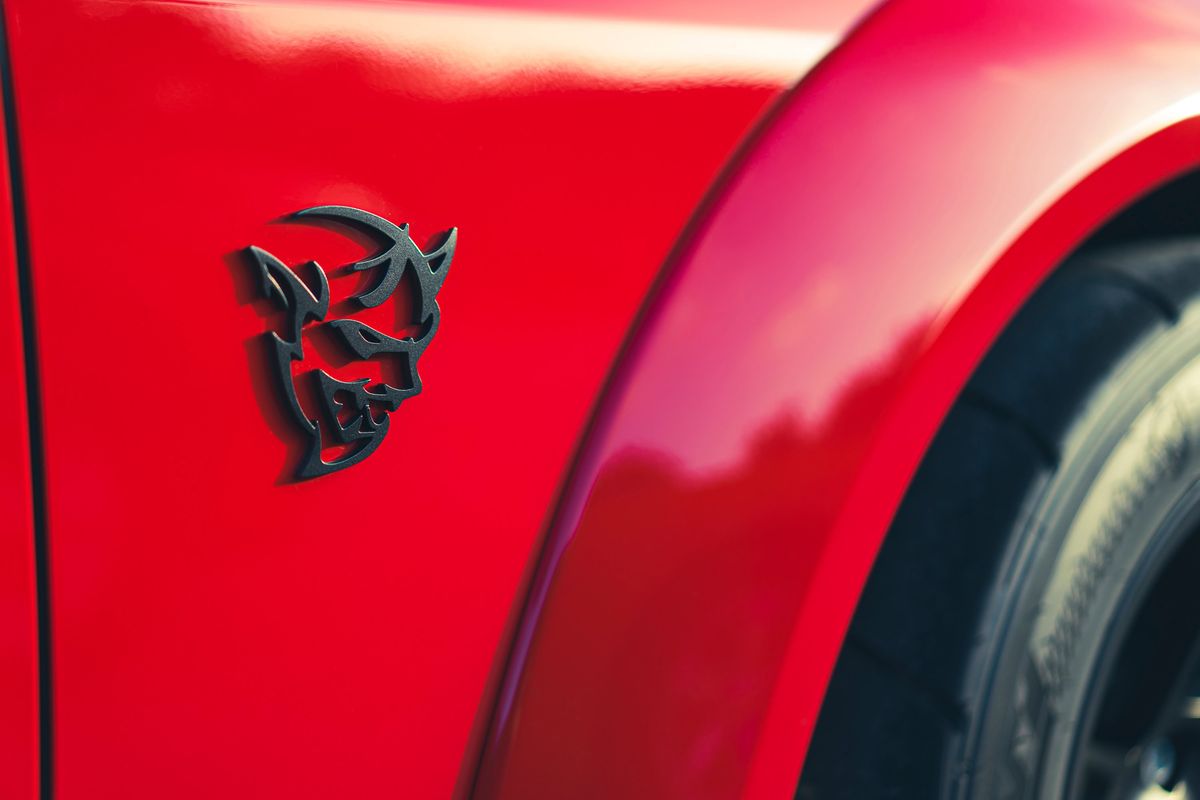 Redline Red Dodge Challenger SRT Demon widebody fender with iconic matte black Demon badge.