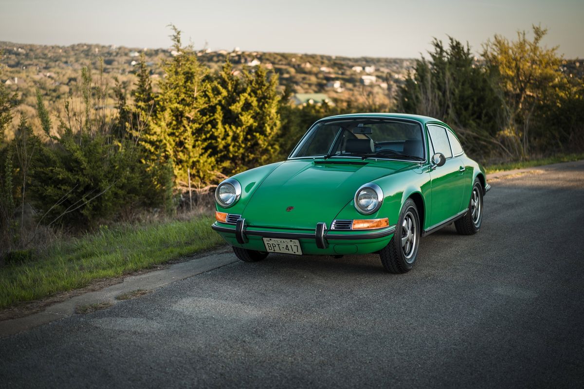 1971 Conda Green Porsche 911E coupe with polished chrome trim and iconic Fuchs-style alloy rims.
