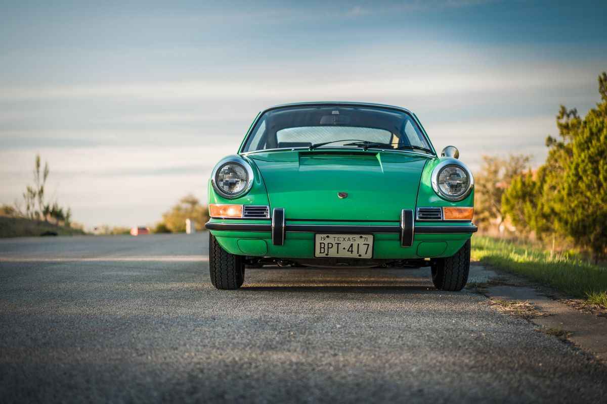 Conda Green 1971 Porsche 911E front view. Features chrome headlight surrounds, bumper guards, and period-correct wheels.