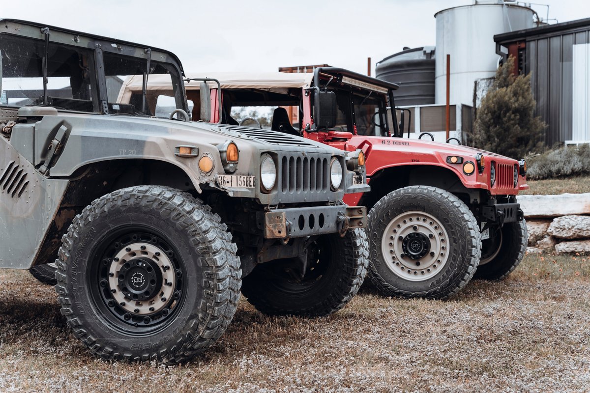 Camo-green Hummer H1 with rugged Cooper Discoverer S/T Maxx tires on Black Rhino multi-spoke rims.