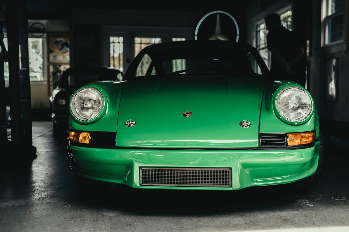 Viper Green classic Porsche 911 front, showcasing round headlights, iconic Porsche crest, and custom RSR-style front valance.