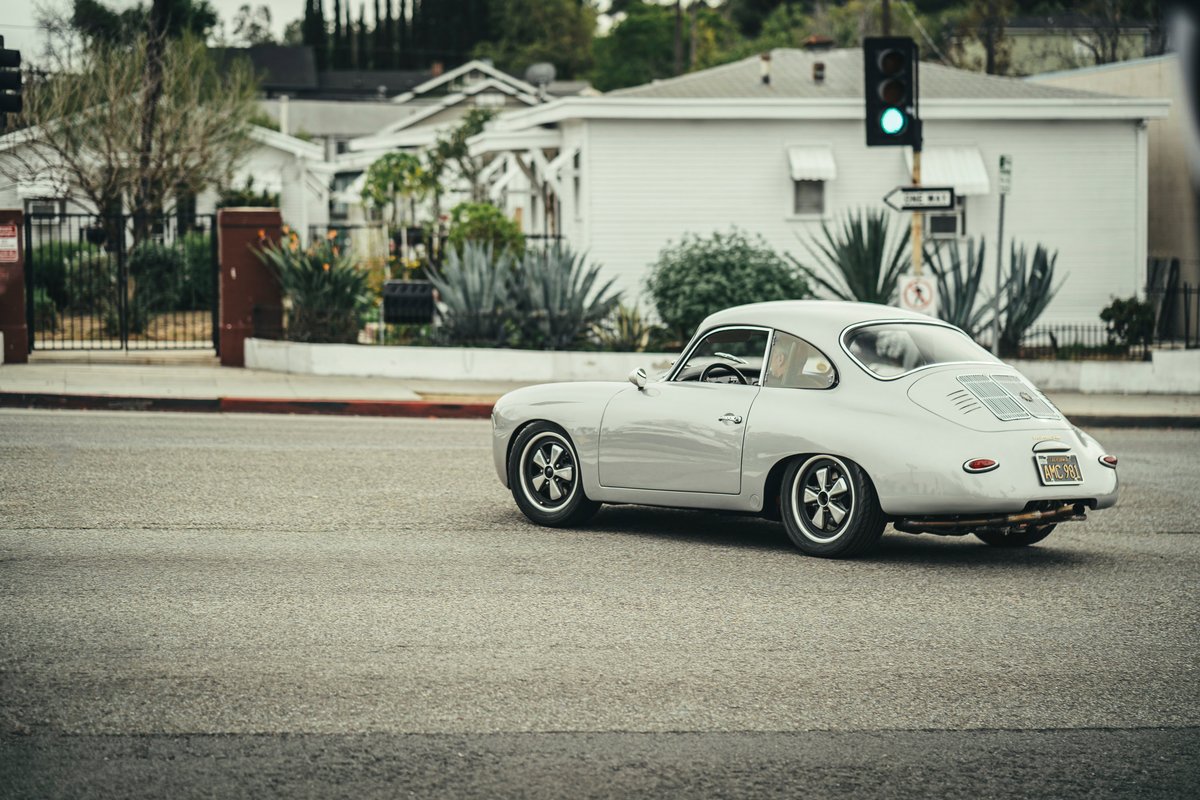 Light grey Porsche 356 outlaw coupe with black Fuchs-style rims, lowered stance in LA.