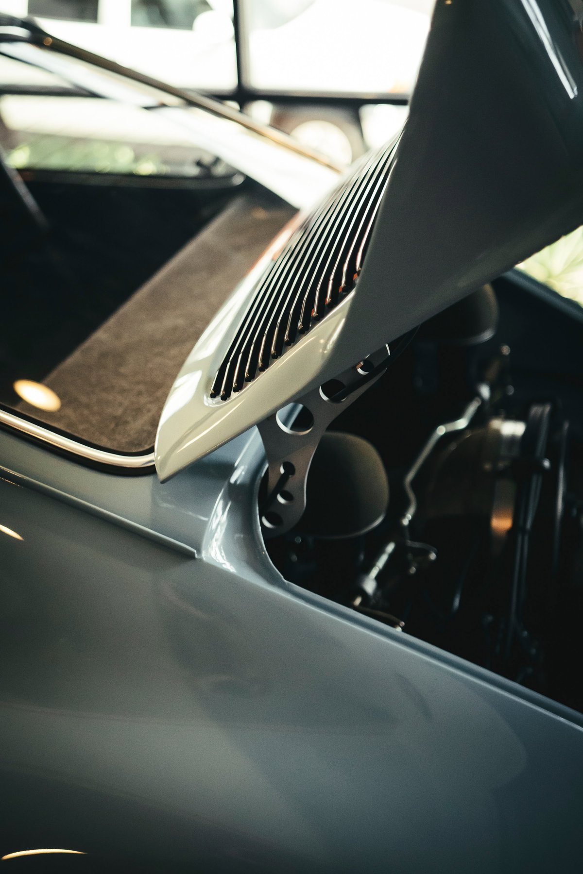 Air-cooled Porsche 911's slate grey rear decklid with vertical engine vents and bespoke lightweight drilled hinges.