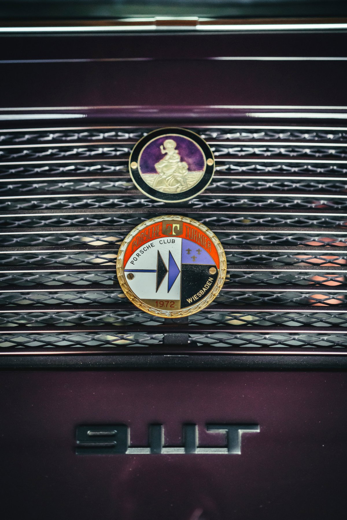 Dark metallic purple Porsche 911T rear grille, featuring vintage Porsche Club Wiesbaden 1972 and cherub badges.