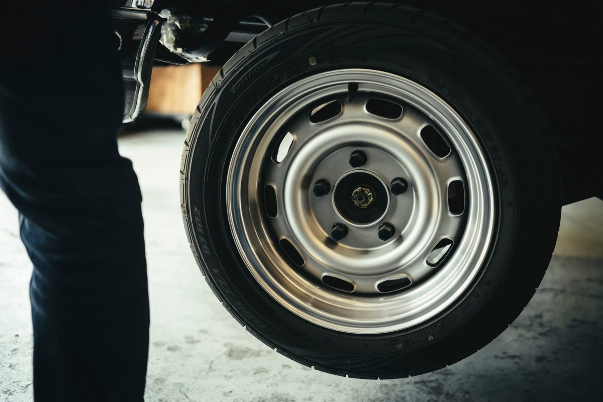 Classic JDM car's silver multi-hole steelie-style rims, polished lip, and performance tire at Lit Show LA.