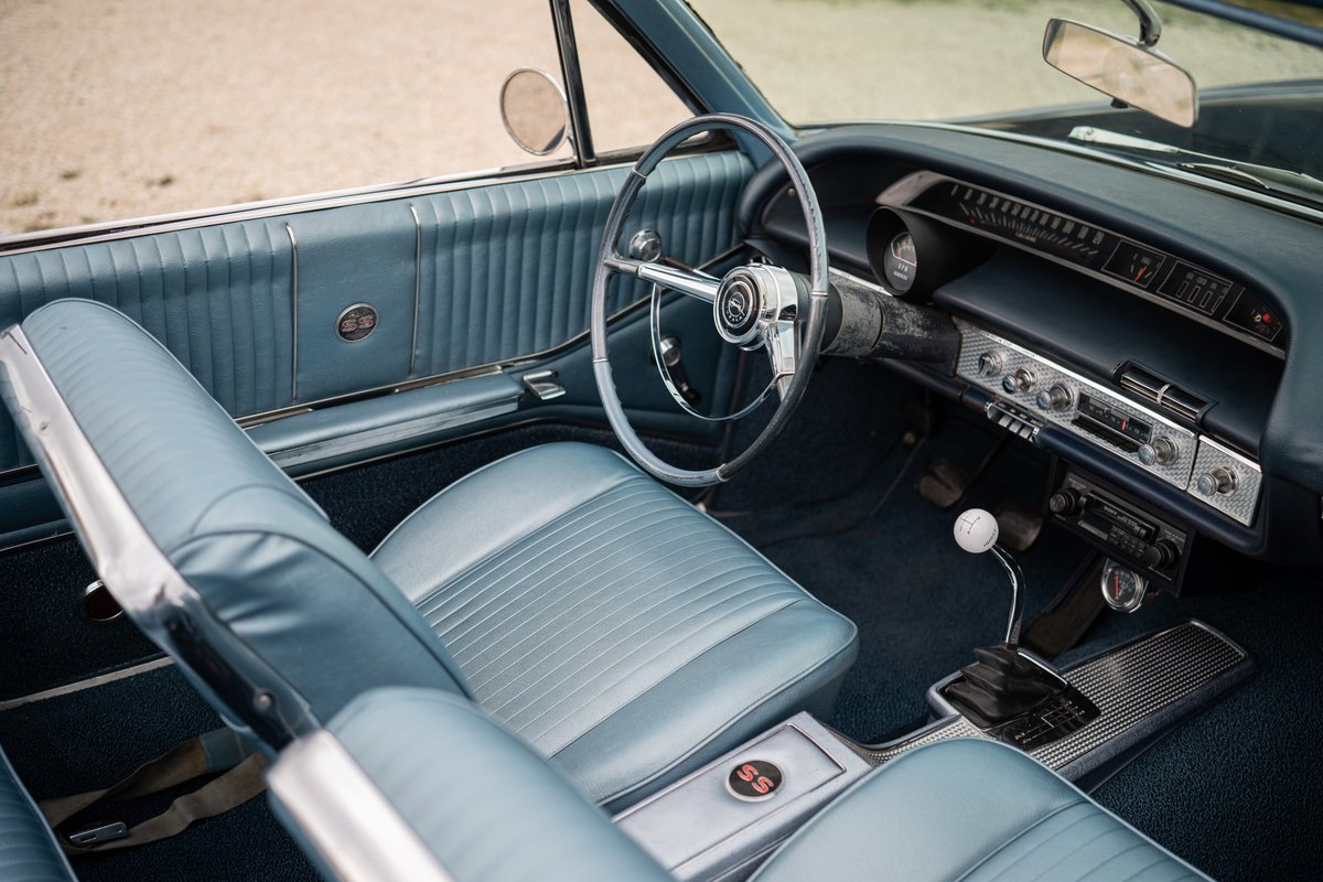 1964 Chevrolet Impala SS interior, blue vinyl seats and door trim.