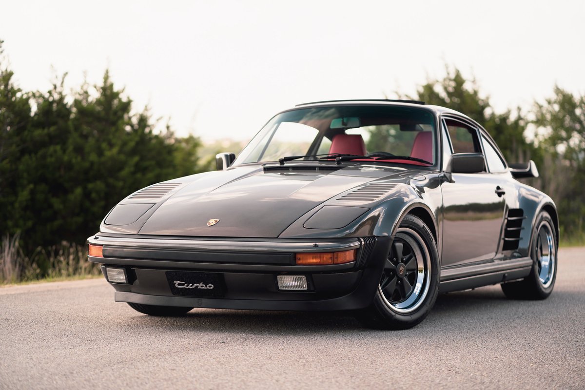 1989 Porsche 930 Turbo Flachbau coupe with red interior and black Fuchs rims.