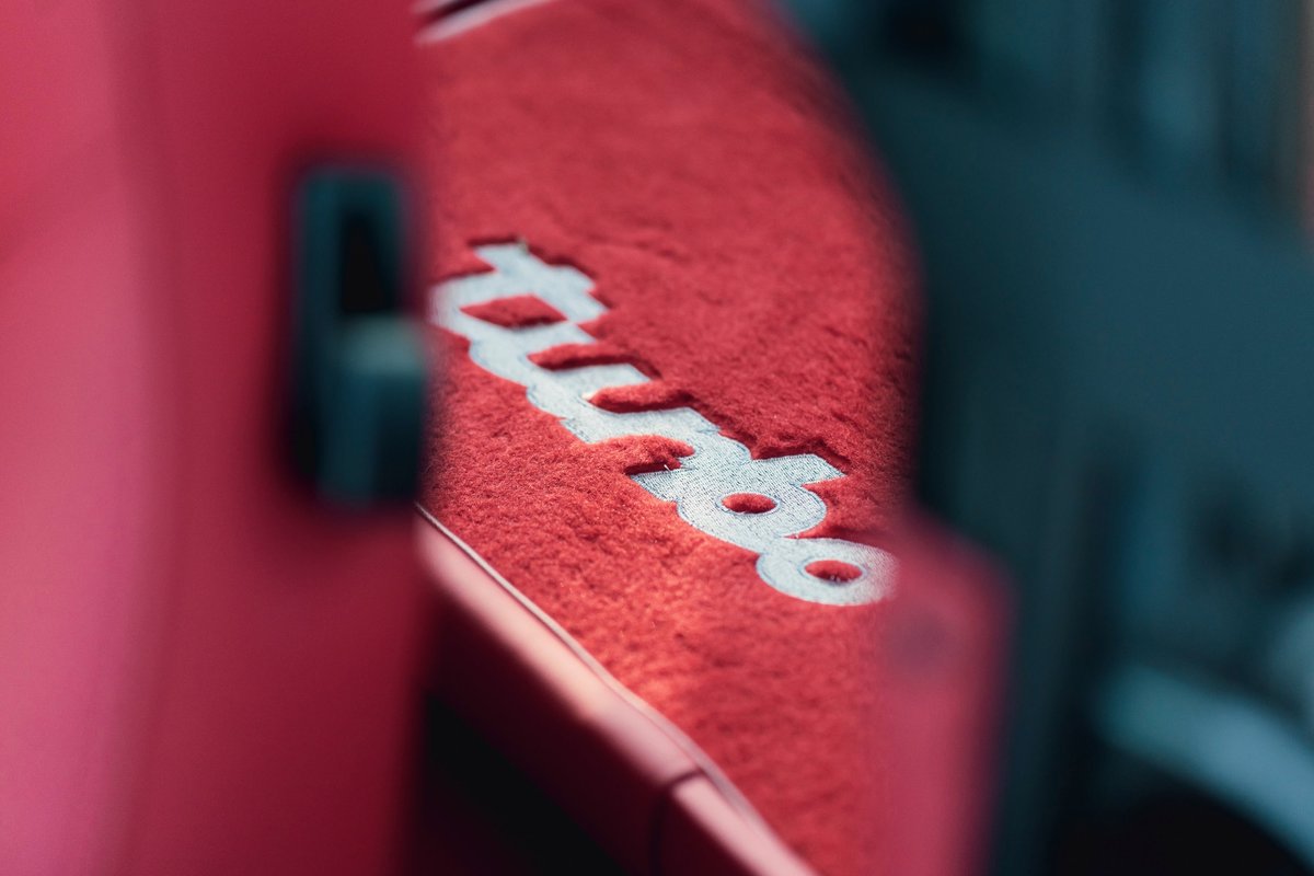 Close-up of red interior carpet with "Turbo" text on a 1989 Porsche 930 Flachbau.