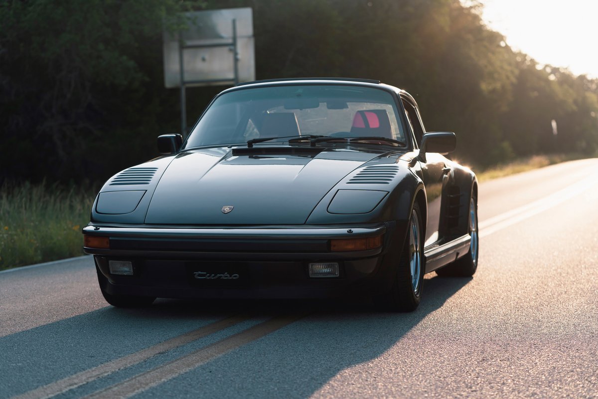 1989 Porsche 930 Turbo Flachbau in black, with a sporty stance and classic turbo trim.
