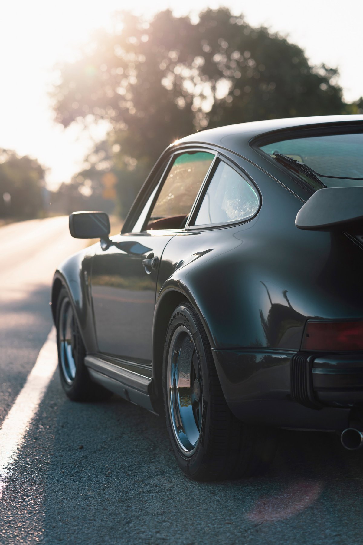 1989 Porsche 930 Turbo Flachbau coupe, black metallic, classic Fuchs rims.