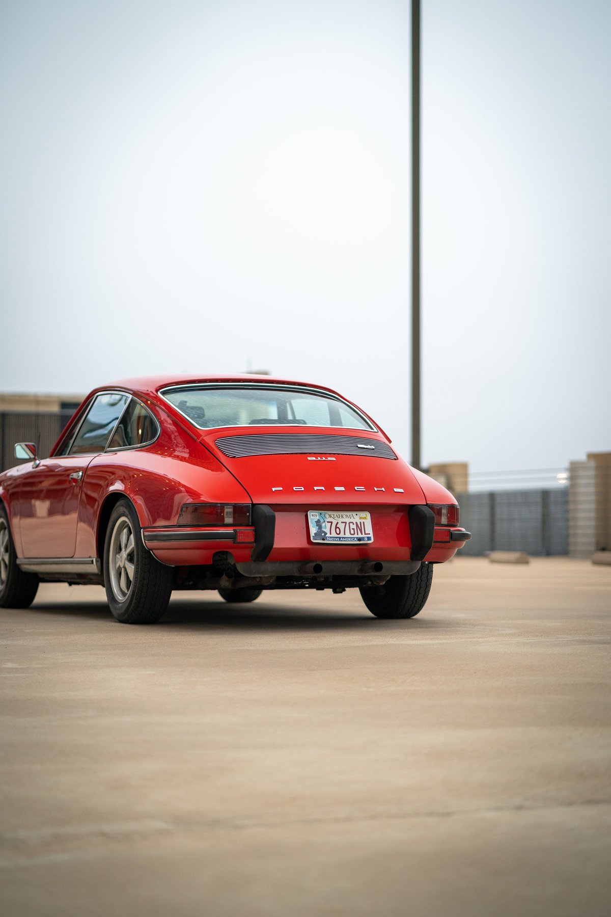 Red 1973 Porsche 911S rear view, showing chrome trim and classic rims.