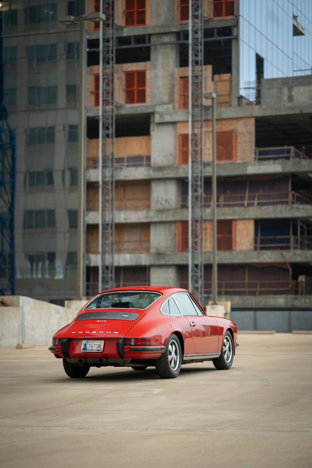 Red 1973 Porsche 911S rear view, showcasing its classic trim and silver rims.