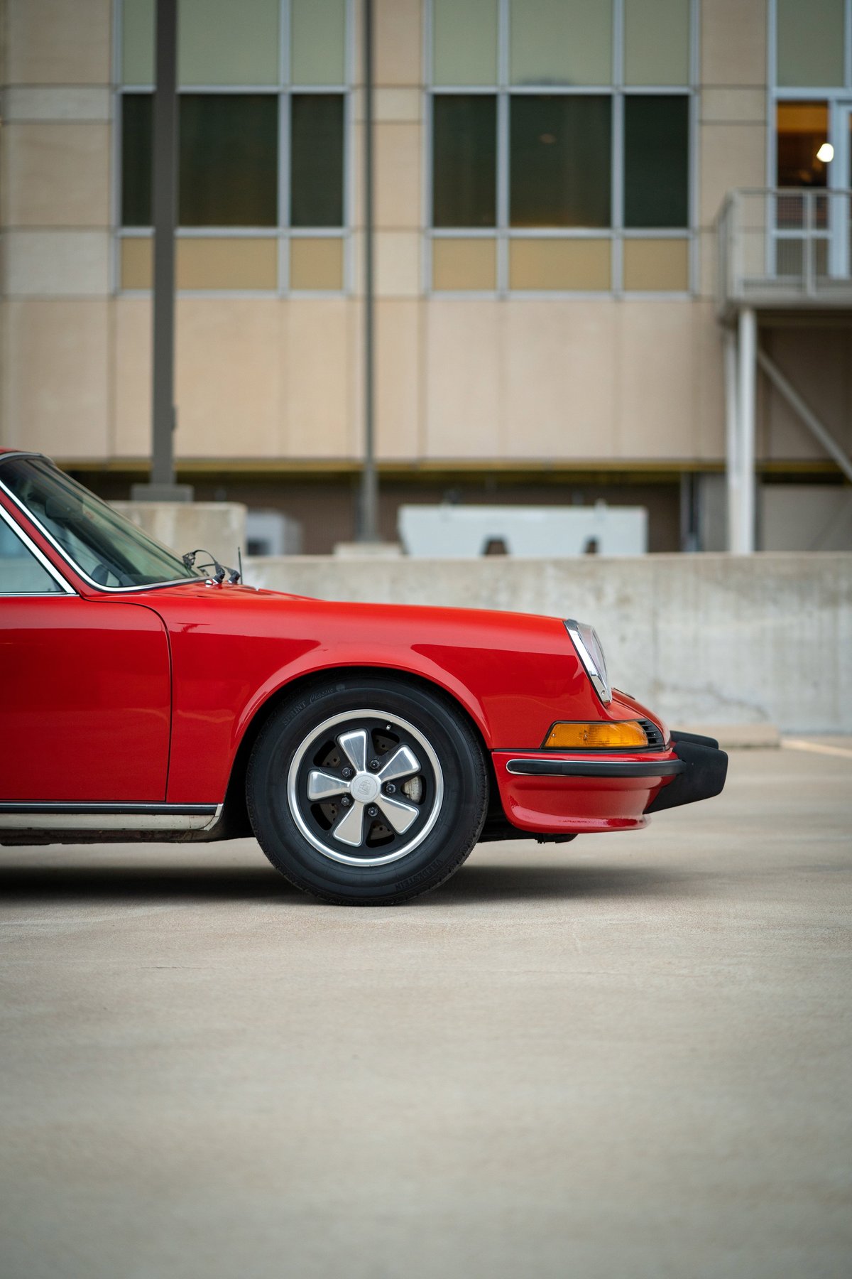 1973 Porsche 911S in Bahia Red, front quarter view, showing Fuchs rims and chrome trim.