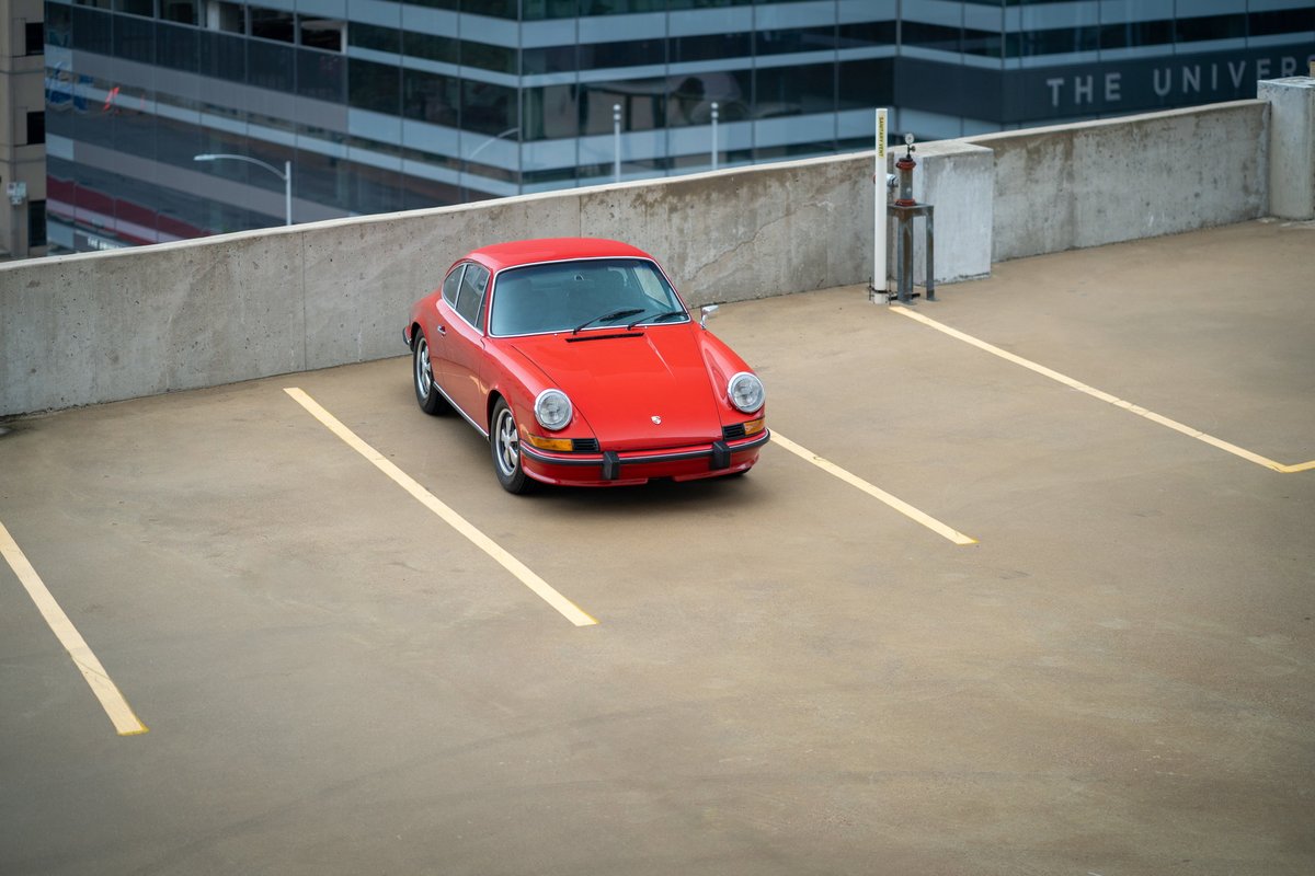 1973 Porsche 911S in Bahia Red, parked on a rooftop.