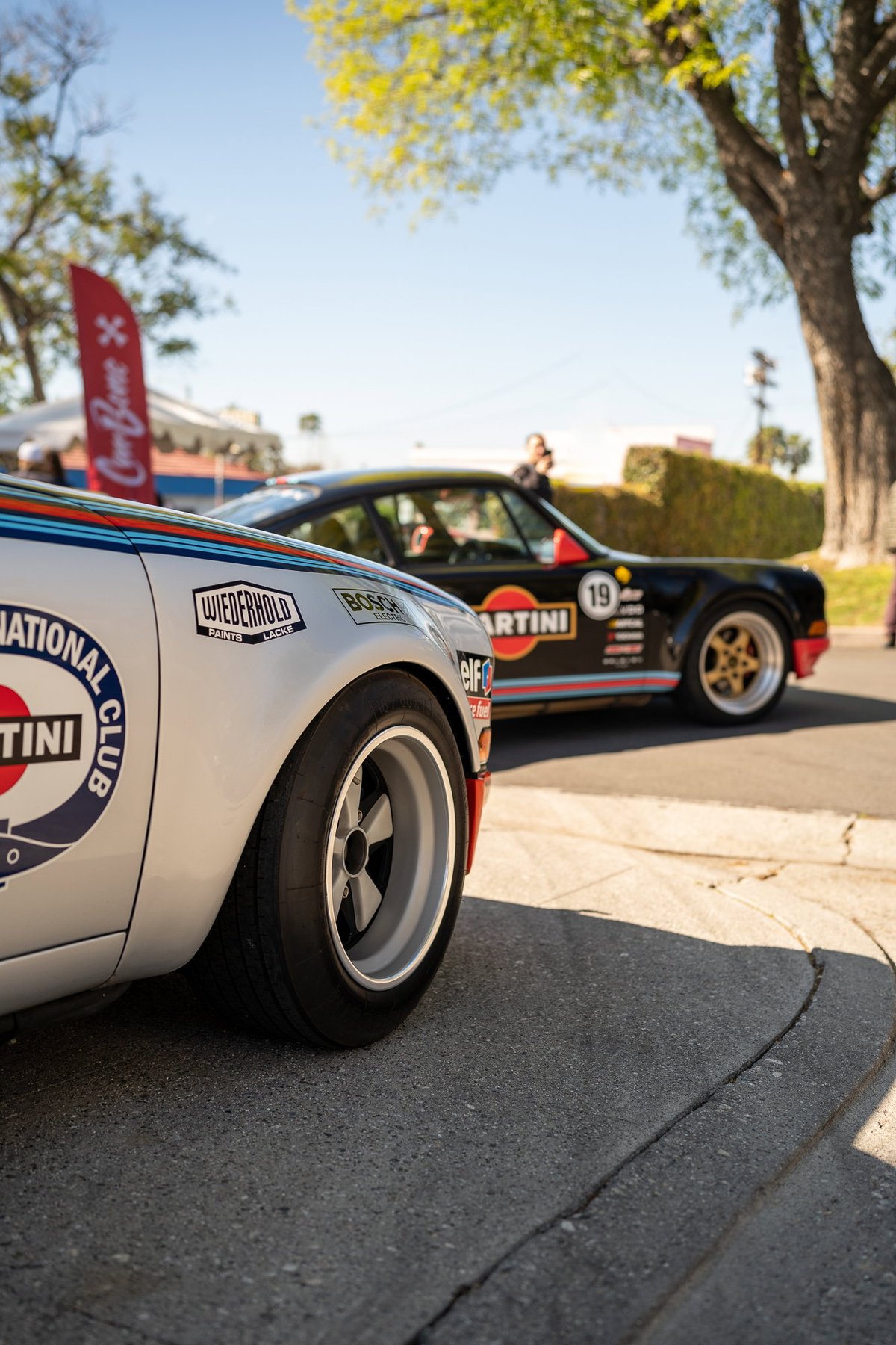 Silver Porsche 911 with Martini livery and classic Fuchs rims.