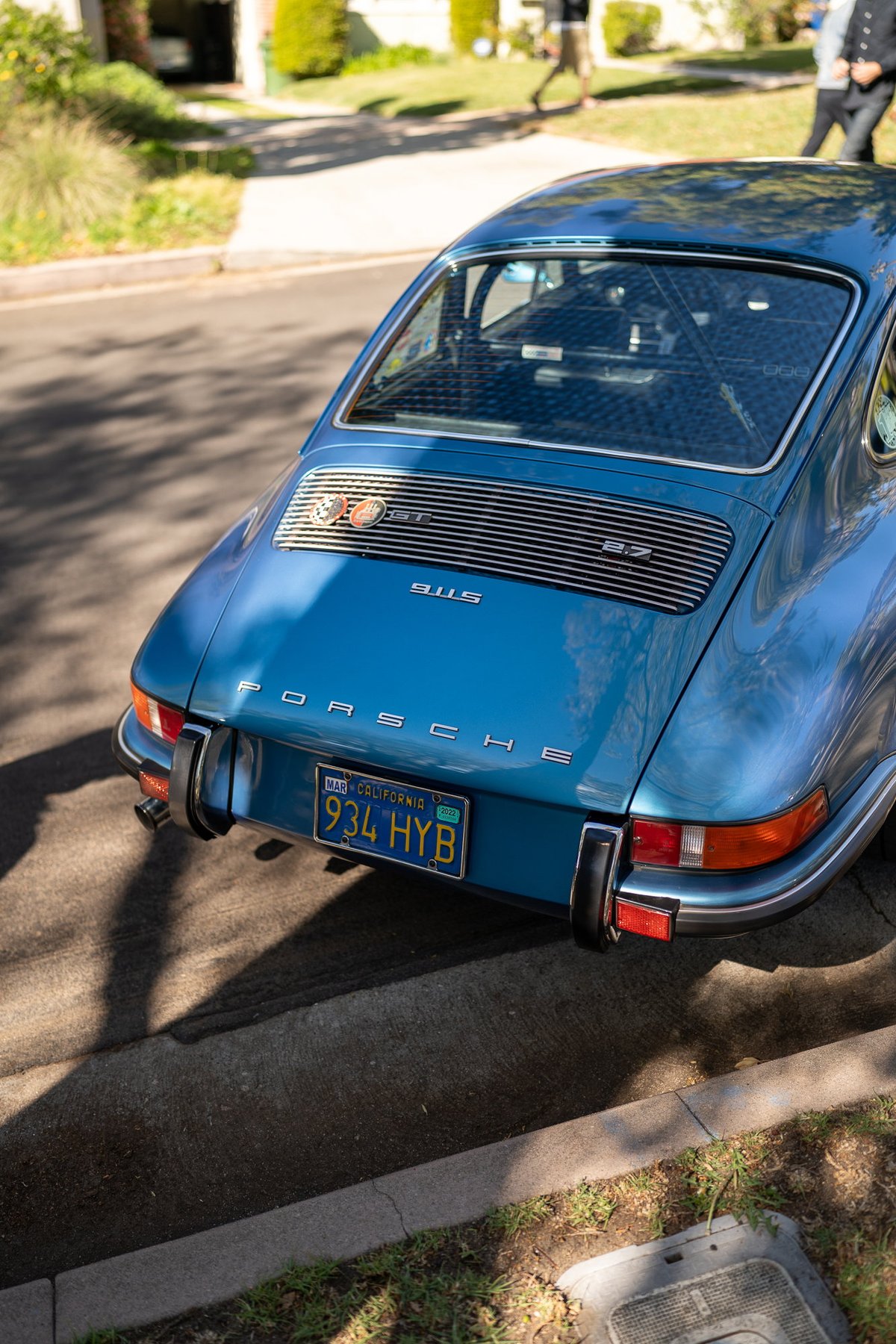 Blue 1973 Porsche 911 Carrera 2.7 RS rear view with yellow California license plate.