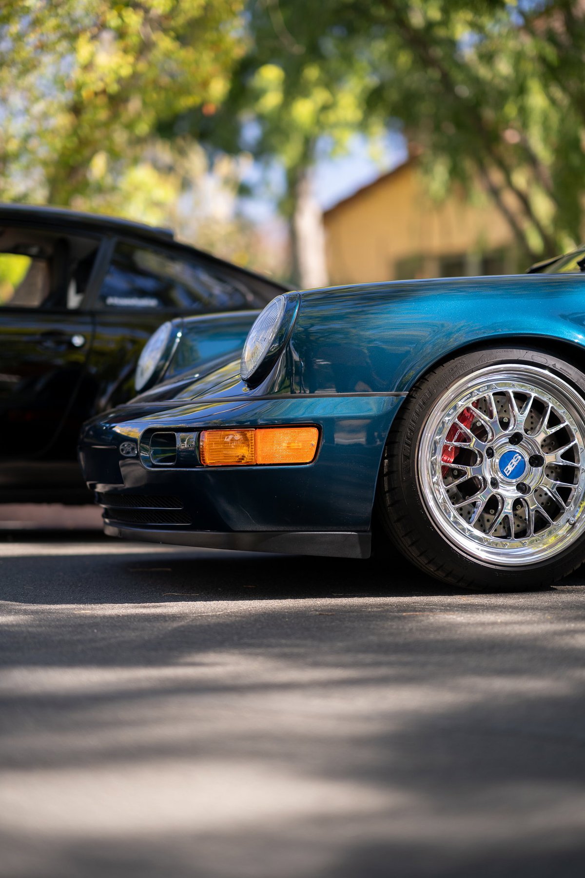 Blue Porsche 911 with BBS rims and red brake calipers.